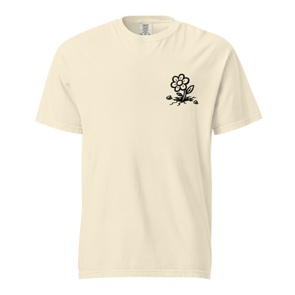Creme farbendes T-Shirt mit kleiner Blume die aus dem Asphlat wächst Print im Brustbereich