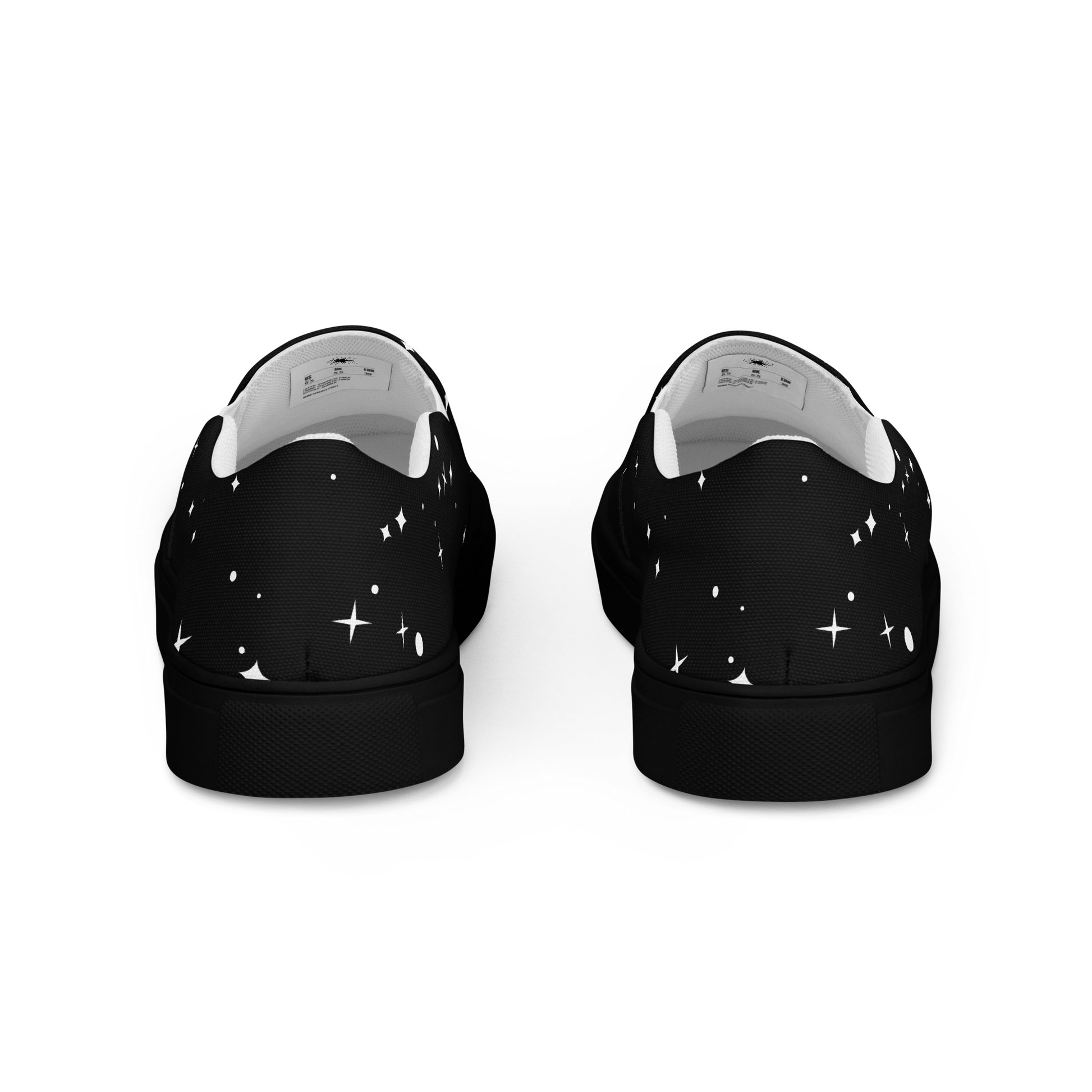 Schwarze Damen Slipper mit weißen Sternen und Punkten bedruckt und schwarzem Gummirand Hintenansicht